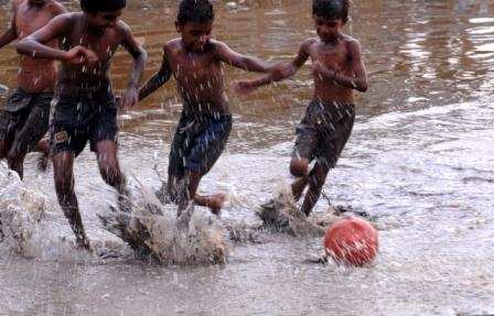 Children Playing Football In Rain